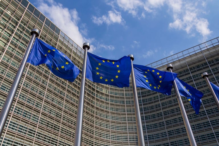 Waving EU flags in front of the Berlaymont building headquarters of the European Commission in Brussels, Belgium