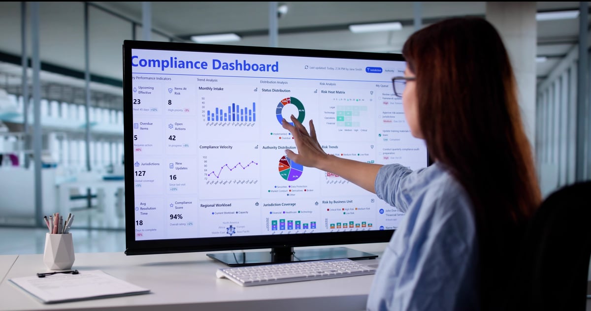 Woman In Business Suit Using Touchscreen Computer To Monitor Regulations.
