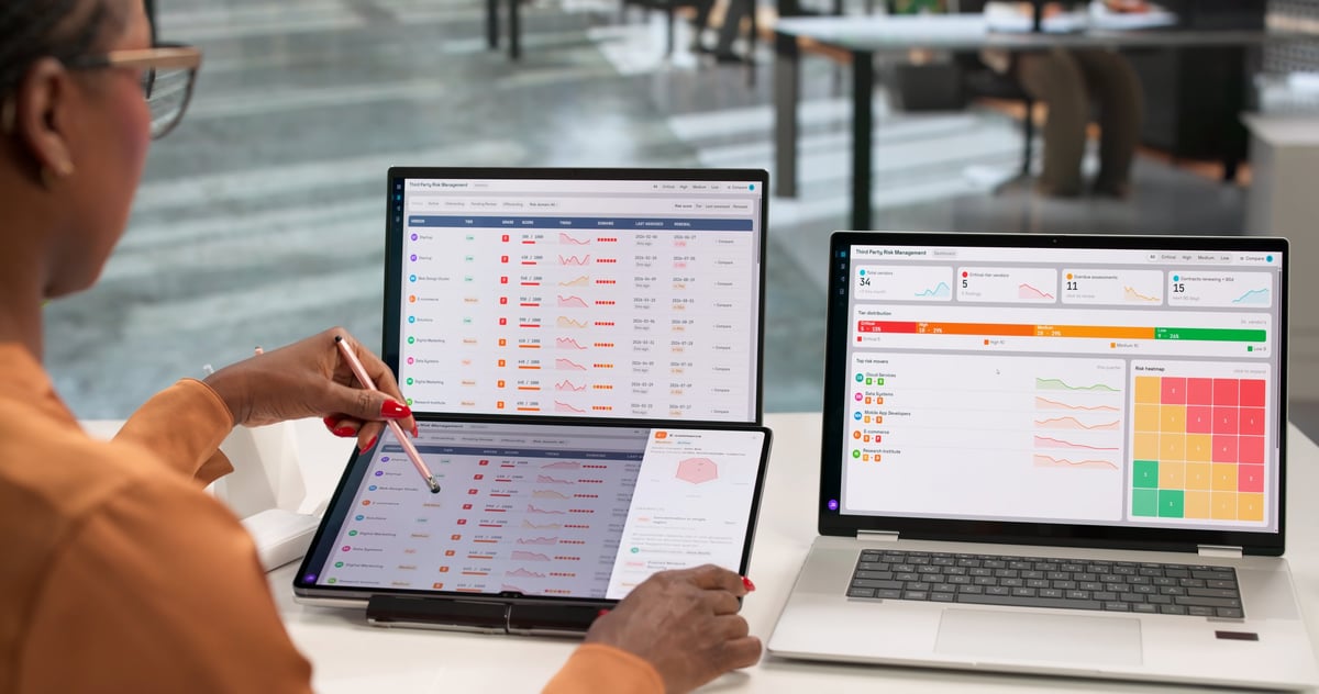 African American Woman Using Laptop To Review Third Party Vendor Risk Data.