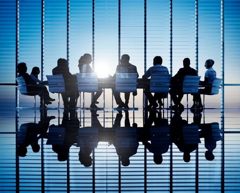 Silhouettes of business people in a conference room.